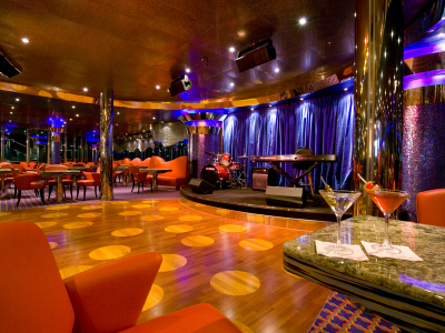 Enjoy a drink listening to live music on a cruise ship.