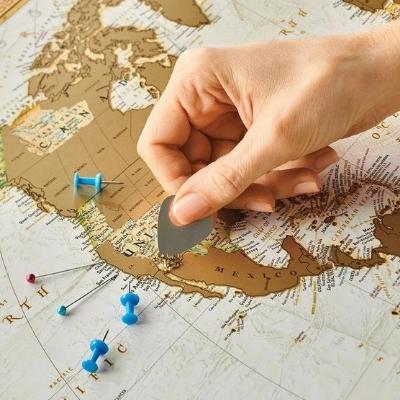 A scratch off world map poster is such a unique travel gift for men.  
Photo by Travel Map Poster