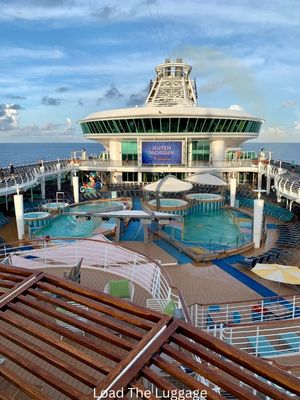 The pools and hot tubs on Mariner of the Seas as well as the outdoor movie screen.  Several reasons in this picture why teens will love Mariner of the Seas


