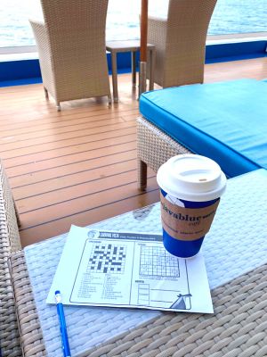 Coffee and puzzle sheet outside on deck 5 of Carnival Vista