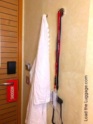 Magnetic hooks used in a cruise stateroom to hang a cover-up and lanyard